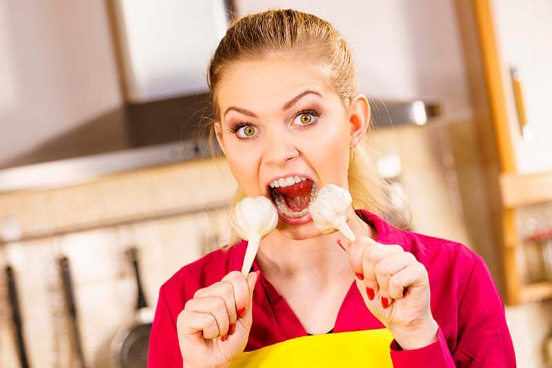 Woman eating garlic